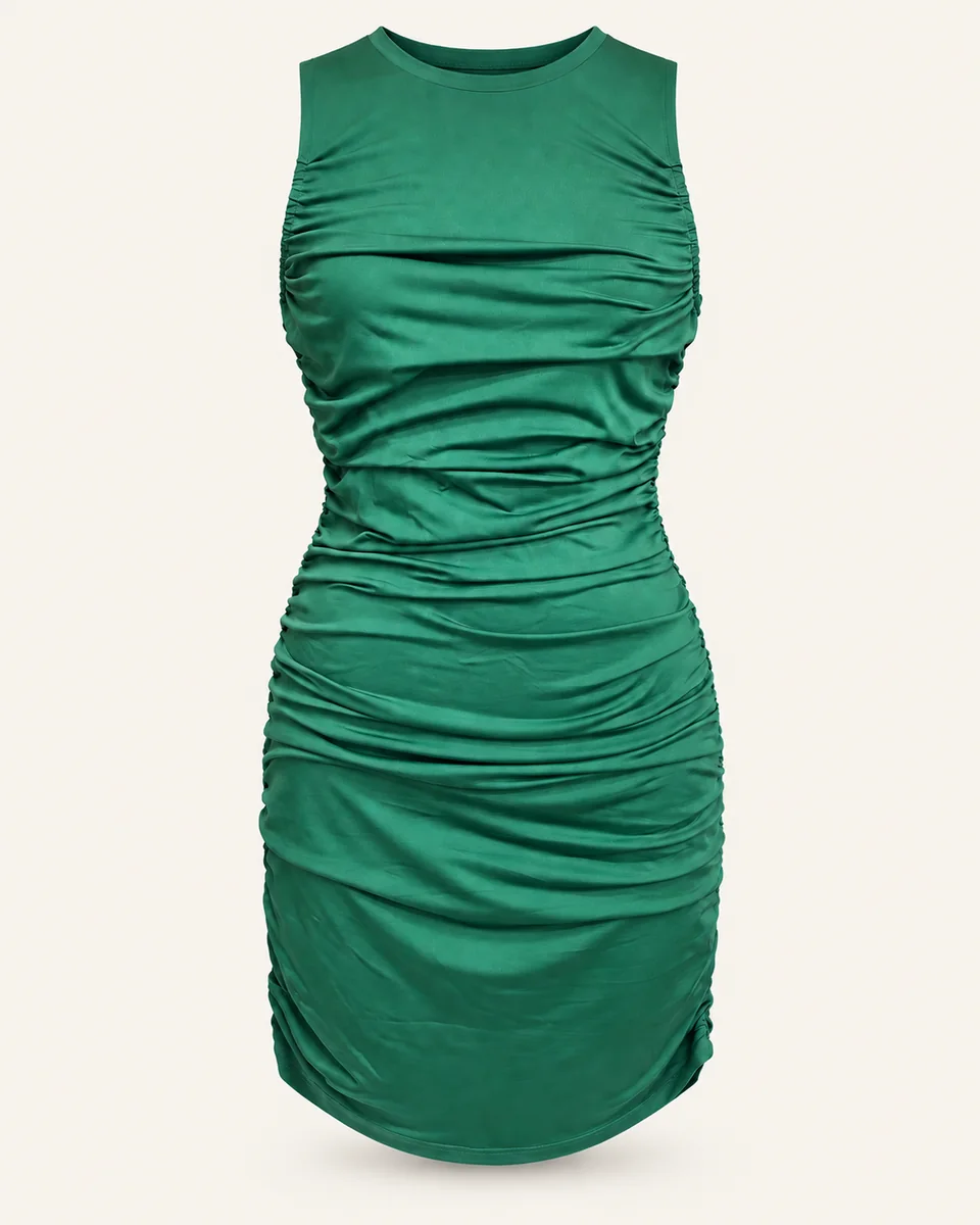 Green sleeveless ruched dress on a warm off-white background