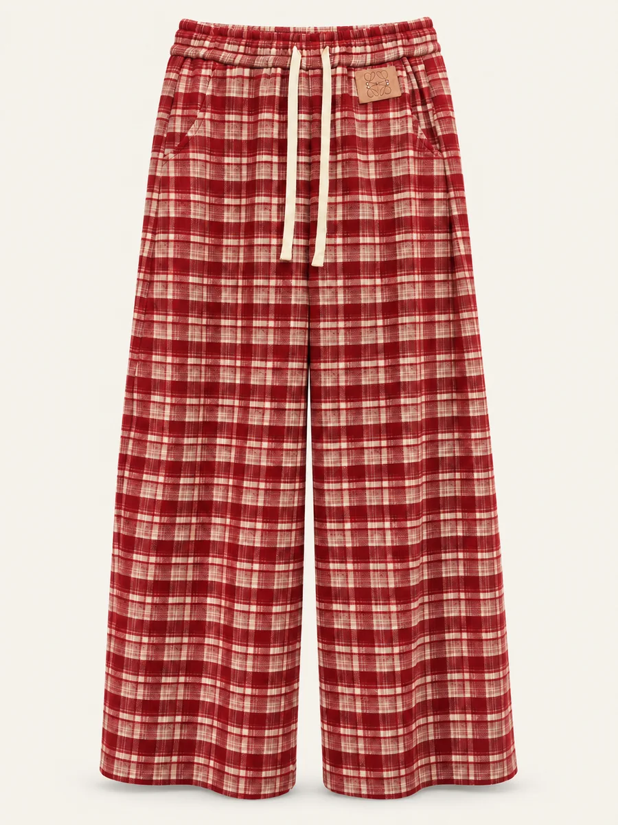 Red plaid wide-leg drawstring trousers on a warm off-white background
